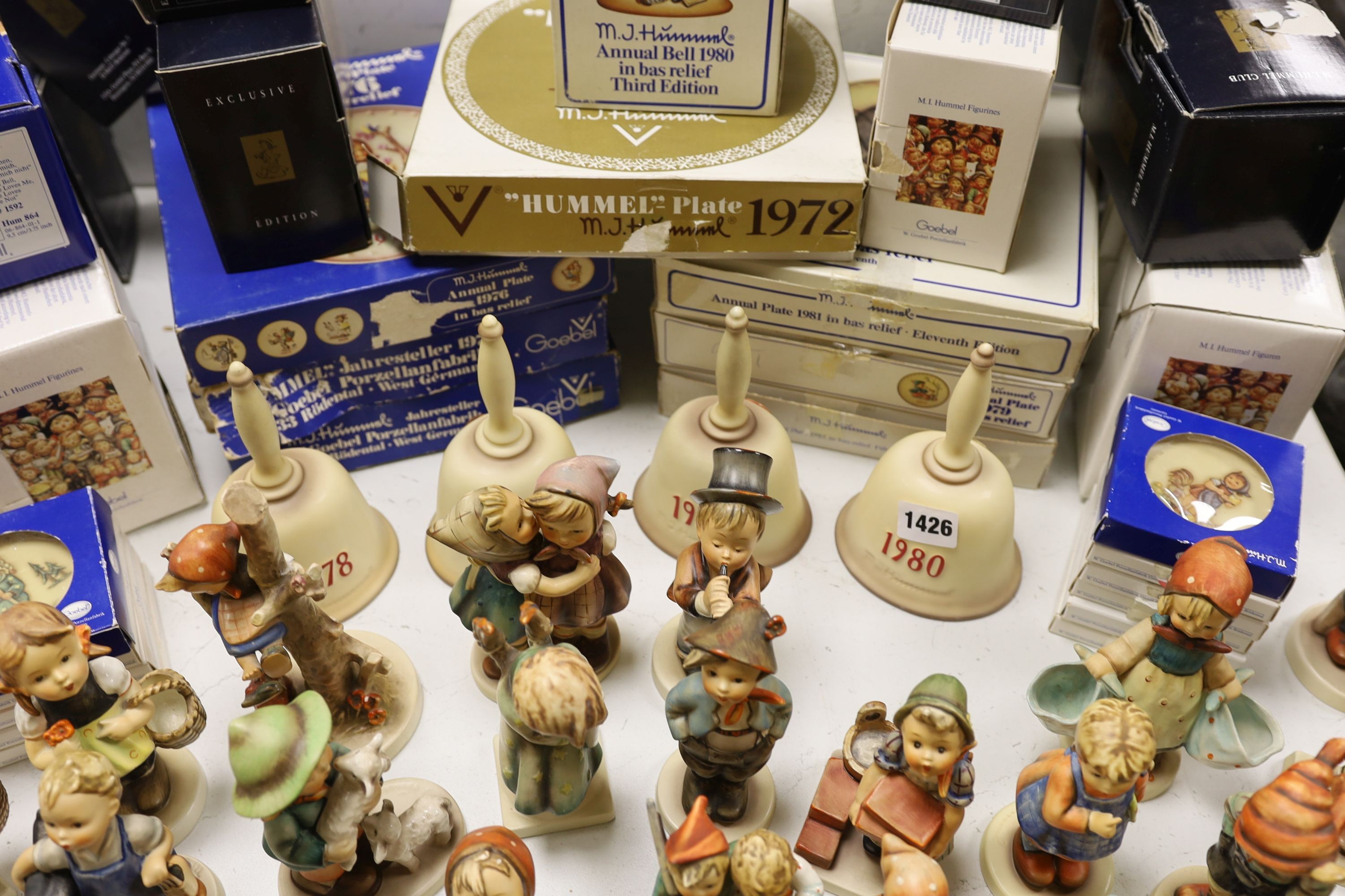 A large collection of Hummel pottery figures, approximately 70 including skier and two similar plaques, some with boxes.